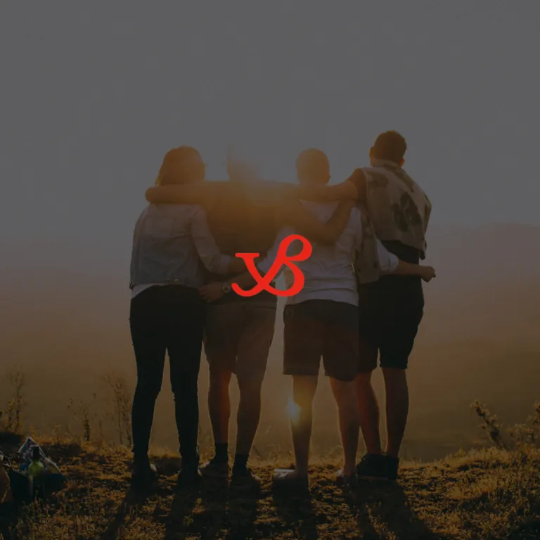 Five friends standing with their arms around each other watching the sunset, with the Buffet logo overlaid